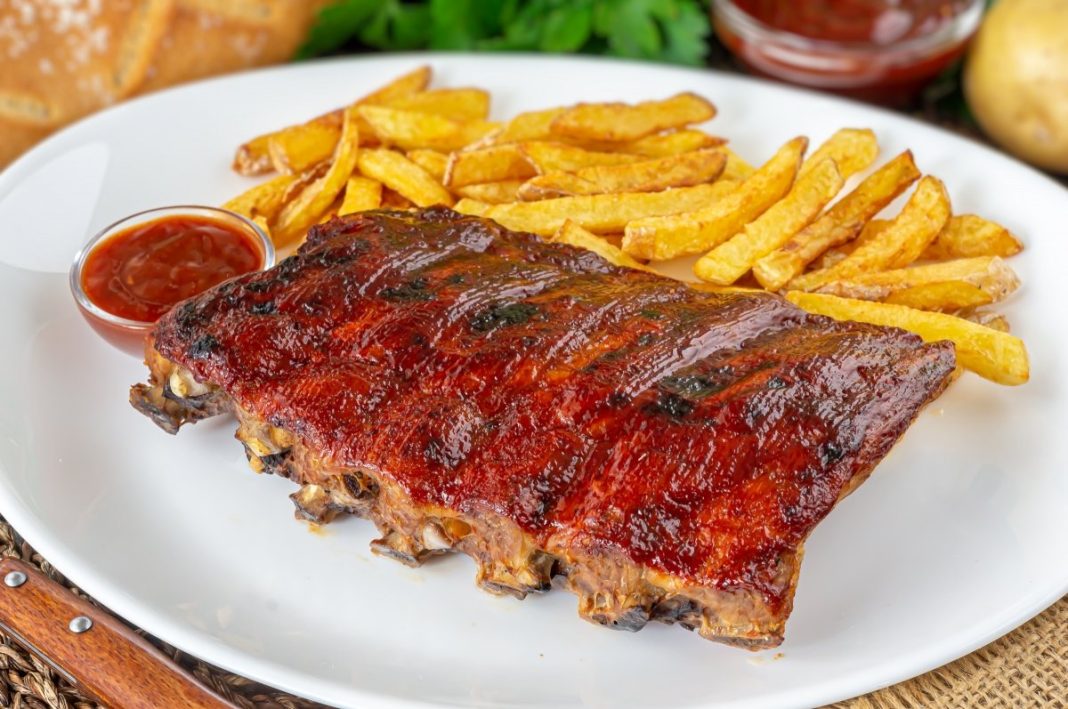 Sirve las costillas de cerdo con las patatas